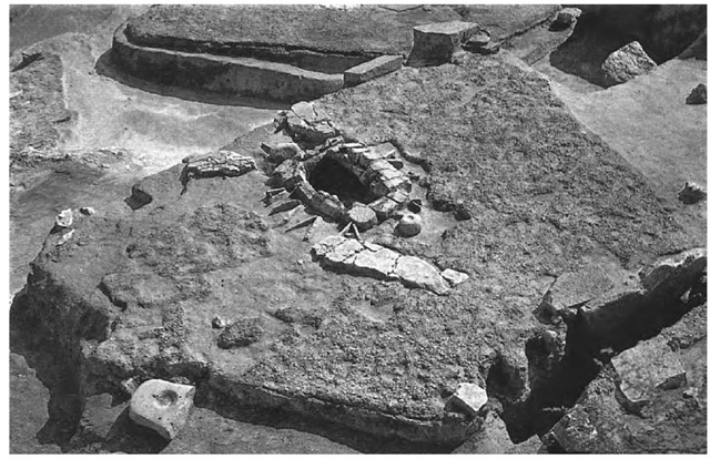 Trapezoidal buildings with carefully laid plaster floors, stone-bordered "hearths," and other stone fixtures are a conspicuous feature of Lepenski Vir. In this example so-called altars—large tabular stones with artificially ground hollows in the upper surface—can be seen set into the floor behind the hearth and adjacent to the near side of the building. Such buildings began to be erected on the site during the Late Mesolithic before 6200 b.c., and their construction continued for at least 500 years during which time pottery and farming were introduced to the region.