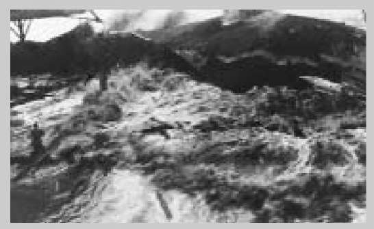 Men survey damage after a 1946 tsunami struck the shore of Hilo, Hawaii.