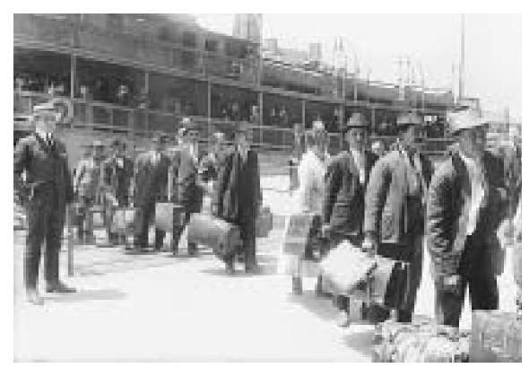 Following a long ocean voyage, 1920 era immigrants to America arrive at Ellis Island, New York. 