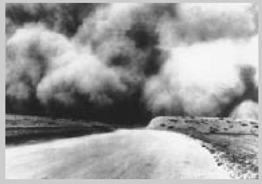 A cloud of topsoil lifts from drought stricken farms and contributes to the accelerated loss of soil during the 1935 Dust Bowl.