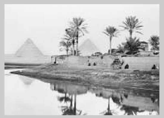 Ancient pyramids dominate the landscape along the Nile River near Giza, Egypt.