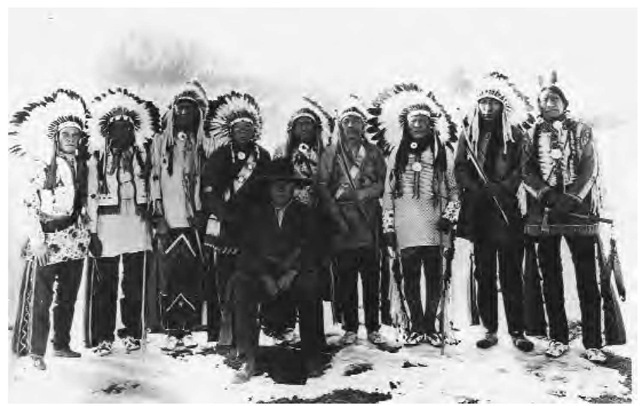 In 1887, the Northern Paiute Wovoka, known to whites as Jack Wilson, originated the Ghost Dance religion. It was based on the belief that the world would be reborn with all Indians, alive and dead, living in a precontact paradise. Wovoka is seen seated in this 1923 publicity photo taken during the filming of the silent-era epic The Covered Wagon.