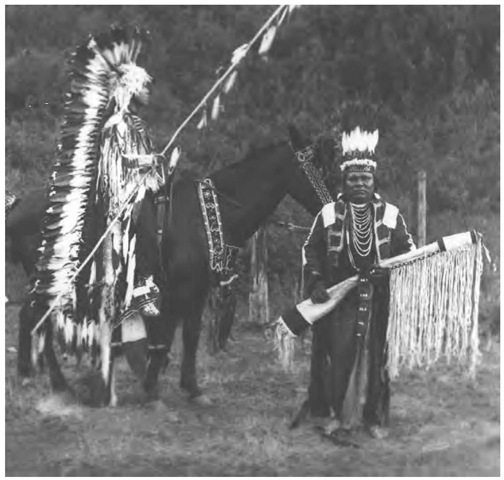Cayuse finery in this early 1900s photograph shows two styles of warbonnets: The horseman wears a halo style with bison horns, and a standup warbonnet is worn by the man holding the heavily fringed rifle scabbard. In common with most Plateau groups, the Cayuse engaged in little raiding or warfare until they acquired horses. The prebattle ceremony included fasting, sweating, praying, and dancing.
