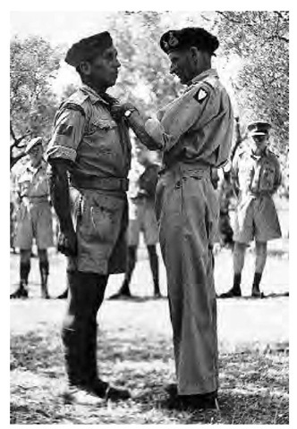 Private Huron Eldon Brant, a Mohawk, served with the Hastings and Prince Edward Regiment during World War II. He is pictured here receiving the military medal for courage in action during the Sicilian campaign.