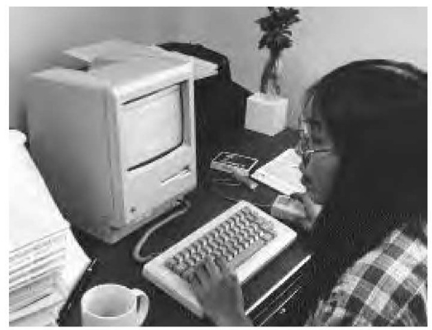 Translator Annie Iola, working with a specially designed word processor keyboard, translates English-language copy into Inuktitut at the Nunatsiaq News, a weekly publication in the northern Canadian town of Igaluit (1987).