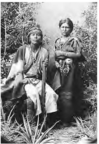 A Navajo couple of the mid-1880s wears silver jewelry and traditionally styled clothing made of nontraditional materials.