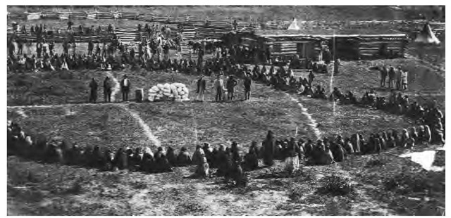 A government agent distributes food rations to Dakota Indians. 