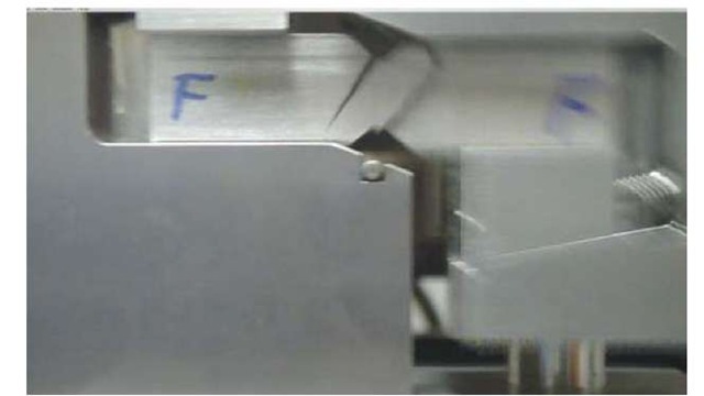 Digital camera video picture caught the crack propagation direction in the Baker ICM beam specimen in the test fixture during the shear test.