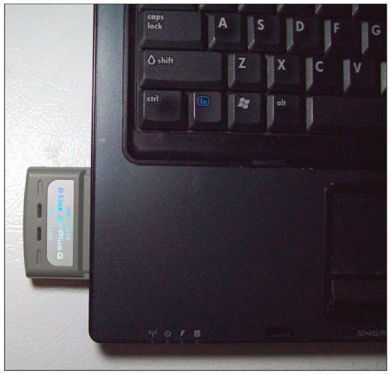 A PC Card that's been inserted into a laptop. 