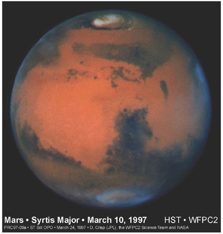 This image of Mars was taken with the WFPC2 on March 10, 1997, just before Mars opposition, when the red planet made one of its closest passes to Earth (about 100 million km). At this distance, a single picture element (pixel) in WFPC2's planetary camera spans 22 km on the Martian surface. The image is less than 335 pixels across—the Martian diameter is 6794 km. This picture was created by combining images taken with blue (433 nm), green (554 nm), and red (763 nm) filters. Credit: STScI-PRC97-09, March 20,1997, David Crisp (JPL) and the WFPC2 Science Team.