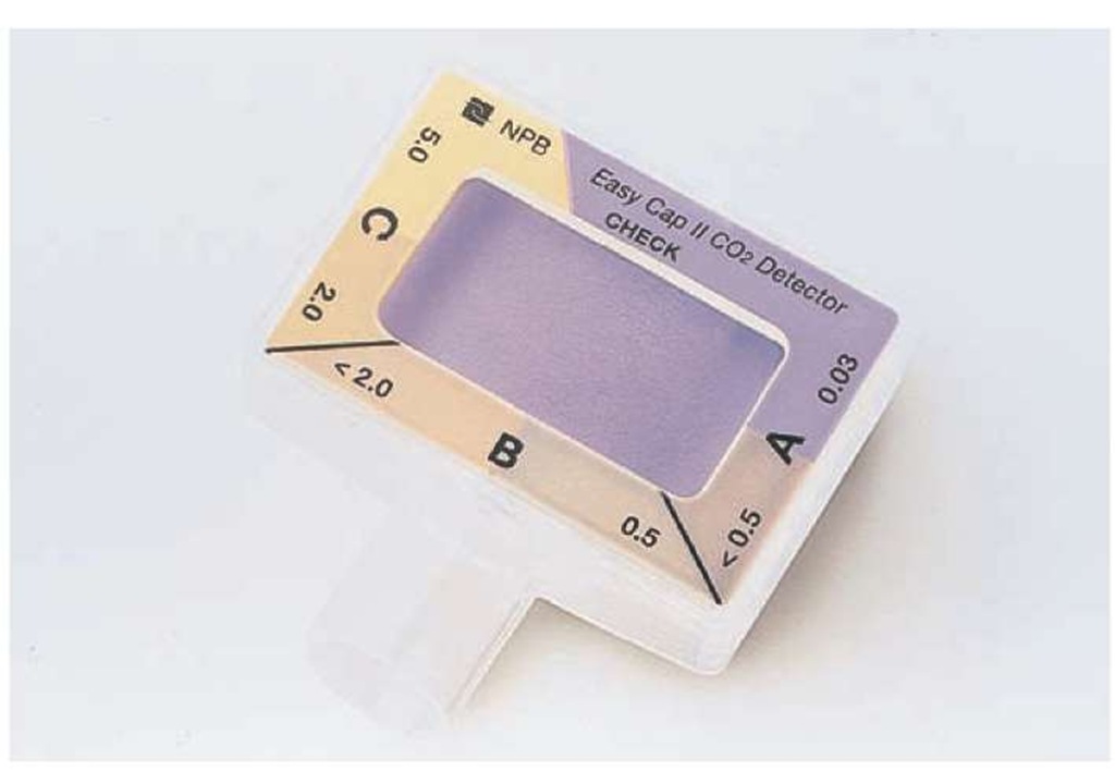The EasyCap® colorimetric capnometer. The color changes from purple when exposed to > 4 mmHg CO2, to tan, and then to yellow when exposed to > 15 mmHg CO2. 