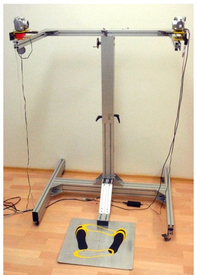 The two-arm stand with fixed two cameras and laser collimators designed for the precise adjustment of the system.