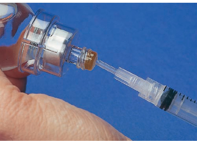Some type of needleless system is usually used to prevent needlestick injuries when administering intravenous (IV) medications, flushing saline locks, or drawing blood. Some needleless systems require the use of a vial adapter, shown here, to draw up medications or saline from a vial.